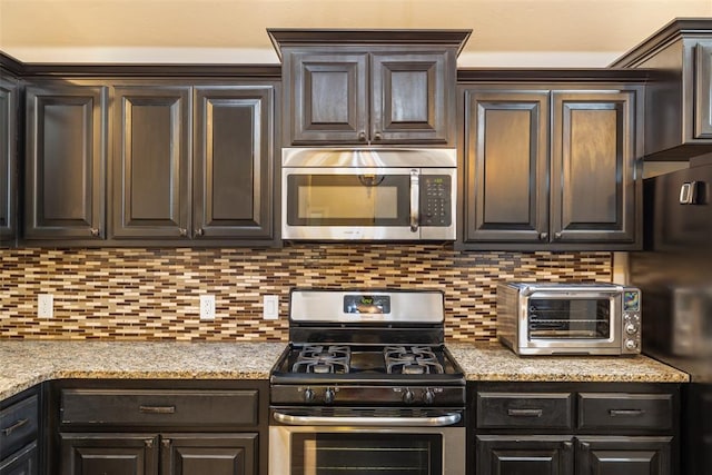 3524 Mount Mitchell Ln, Norman, OK 73069 - kitchen featuring appliances with stainless steel finishes, dark brown cabinets, and tasteful backsplash