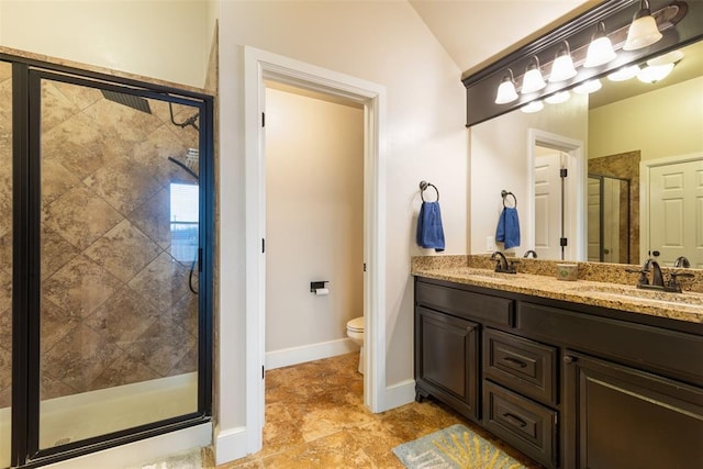 3524 Mount Mitchell Ln, Norman, OK 73069 - bathroom with a shower stall, toilet, double vanity, vaulted ceiling, and baseboards