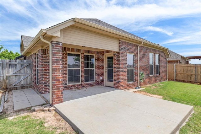 3524 Mount Mitchell Ln, Norman, OK 73069 - back of property featuring brick siding, a patio, and roof with shingles