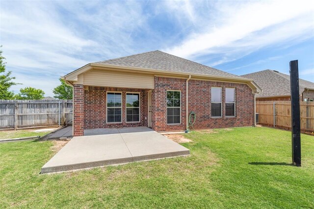 3524 Mount Mitchell Ln, Norman, OK 73069 - back of property with brick siding, a patio area, and roof with shingles