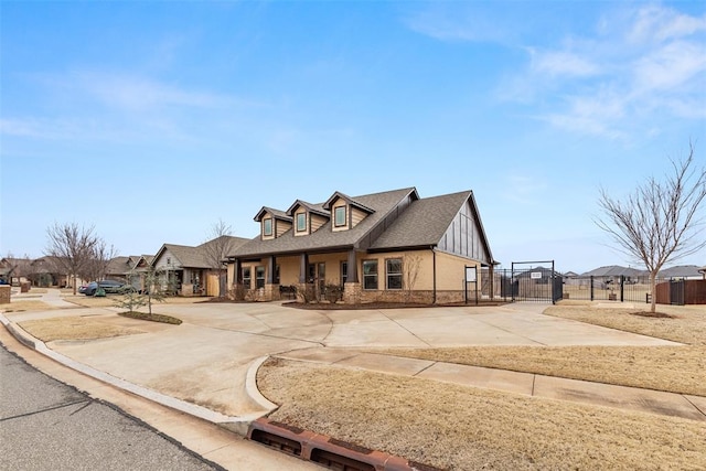 3524 Mount Mitchell Ln, Norman, OK 73069 - view of front of property featuring fence, driveway, stone siding, a gate, and roof with shingles