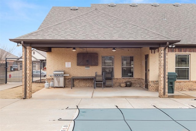 3524 Mount Mitchell Ln, Norman, OK 73069 - back of property featuring roof with shingles, a ceiling fan, fence, a patio area, and brick siding