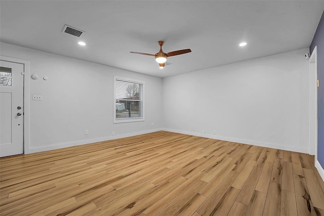 spare room featuring ceiling fan and light hardwood / wood-style flooring