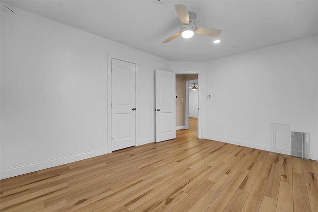 empty room featuring ceiling fan and light hardwood / wood-style flooring