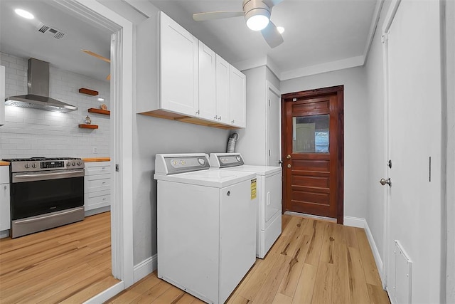 clothes washing area featuring ceiling fan, washing machine and clothes dryer, and light wood-type flooring