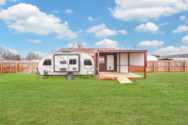 rear view of property featuring a patio and a yard