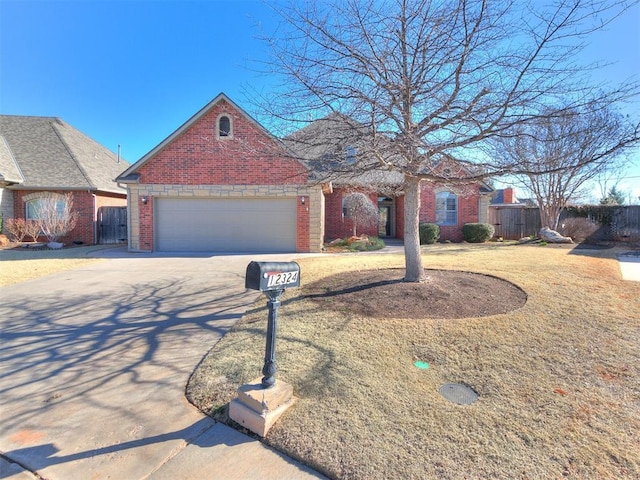 view of front of home with concrete driveway, an attached garage, fence, and brick siding