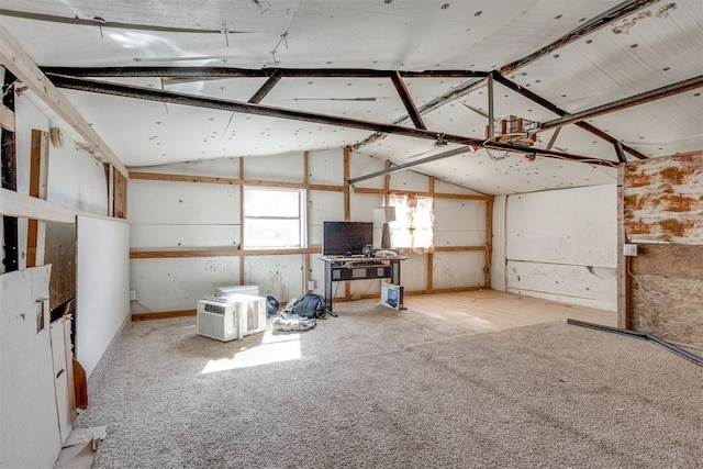 unfurnished living room featuring vaulted ceiling