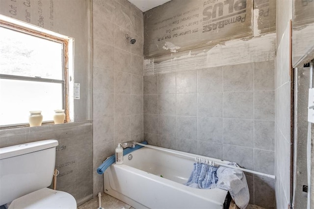 bathroom featuring shower / tub combination and toilet