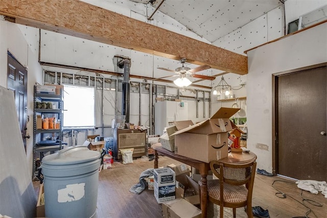 misc room with beamed ceiling, wood-type flooring, and ceiling fan