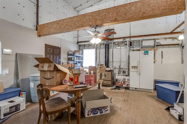 misc room featuring hardwood / wood-style floors, a towering ceiling, and ceiling fan