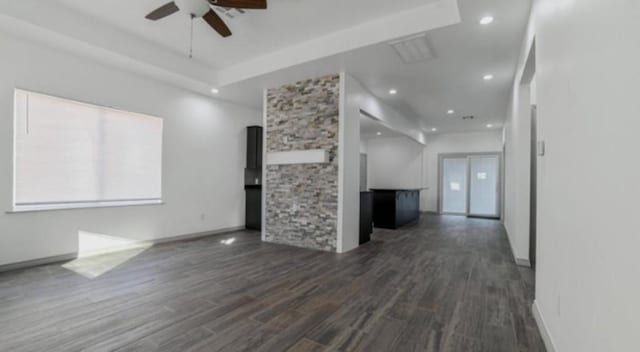 unfurnished living room with dark hardwood / wood-style floors and ceiling fan