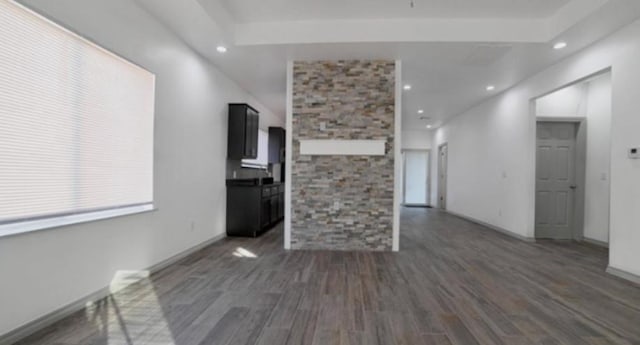 unfurnished living room with dark hardwood / wood-style flooring