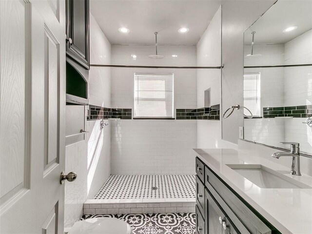 full bath with a tile shower and a wealth of natural light