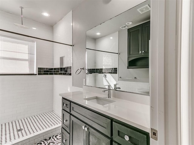 full bath with recessed lighting, visible vents, a tile shower, and vanity