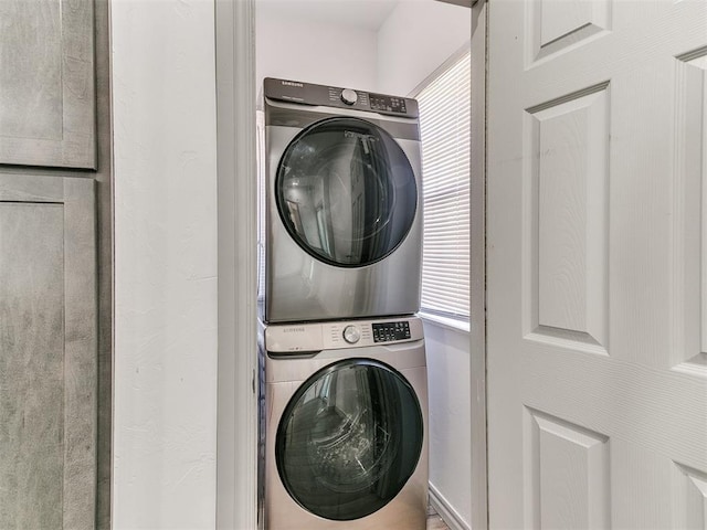 laundry room featuring laundry area and stacked washer / dryer