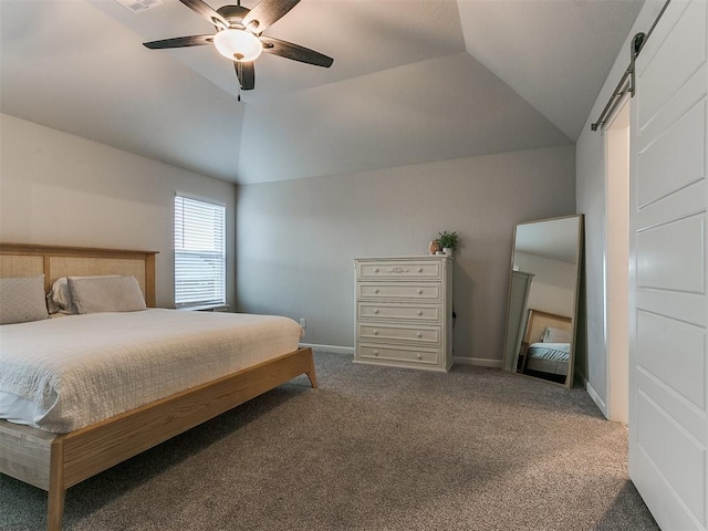 bedroom featuring ceiling fan, carpet flooring, a barn door, and vaulted ceiling