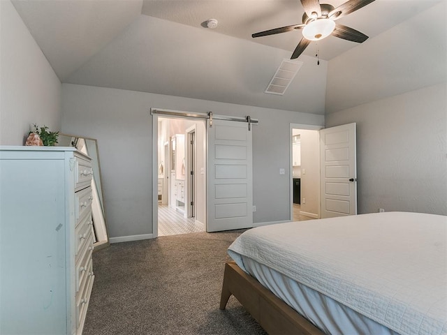 bedroom featuring ensuite bathroom, vaulted ceiling, carpet floors, ceiling fan, and a barn door