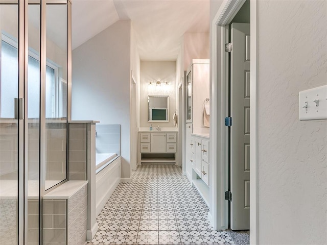 bathroom with lofted ceiling, vanity, and shower with separate bathtub