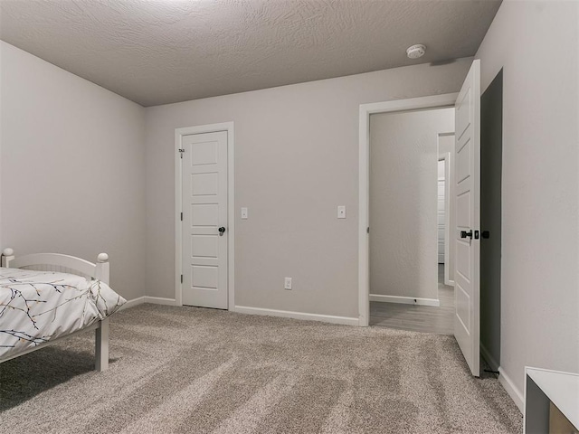 carpeted bedroom with a textured ceiling