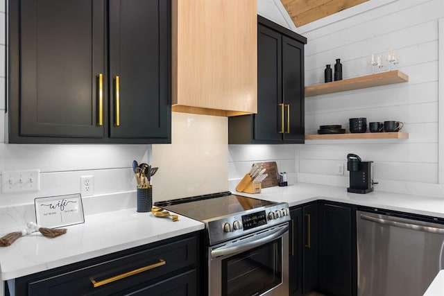 kitchen with appliances with stainless steel finishes, light stone countertops, and backsplash