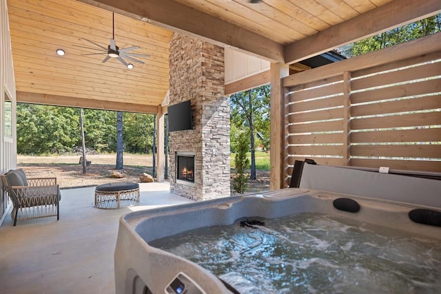 view of patio featuring ceiling fan and an outdoor stone fireplace