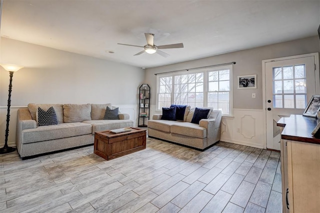 living room featuring light hardwood / wood-style flooring and ceiling fan