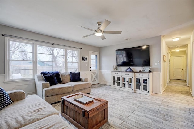 living room with ceiling fan and light wood-type flooring