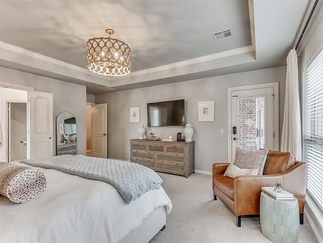 carpeted bedroom featuring an inviting chandelier, ornamental molding, a tray ceiling, and access to exterior