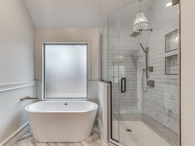 bathroom featuring separate shower and tub