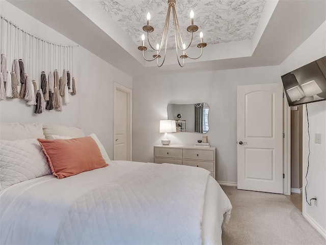 bedroom with light colored carpet, a raised ceiling, and a notable chandelier