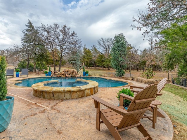 view of pool with an in ground hot tub and a patio