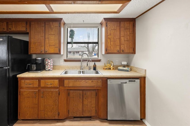 kitchen with sink, black fridge, a textured ceiling, light wood-type flooring, and dishwasher