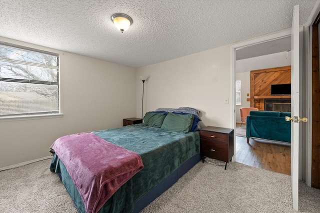 bedroom featuring light colored carpet and a textured ceiling