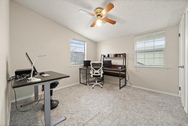 carpeted office space with ceiling fan, lofted ceiling, and a textured ceiling