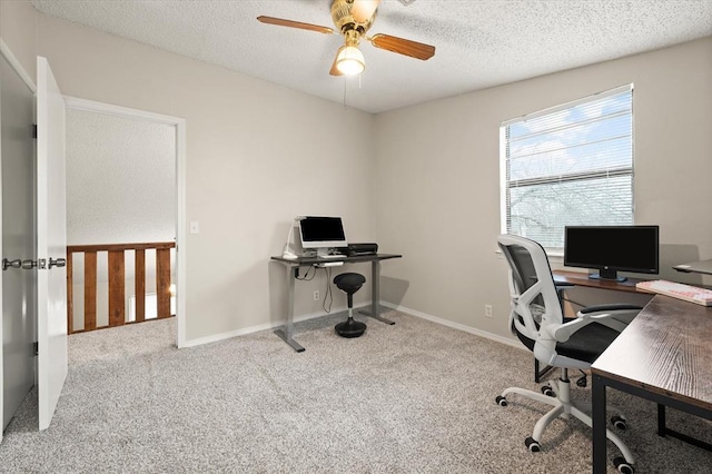 office space featuring ceiling fan, light carpet, and a textured ceiling