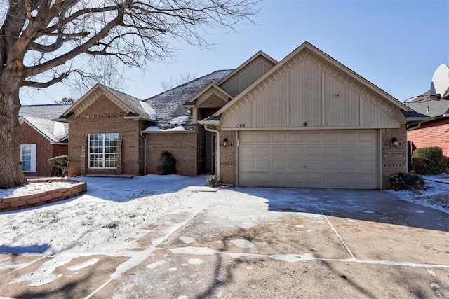 view of front of home with concrete driveway, an attached garage, and brick siding