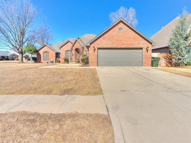 view of front of home with concrete driveway, brick siding, and an attached garage