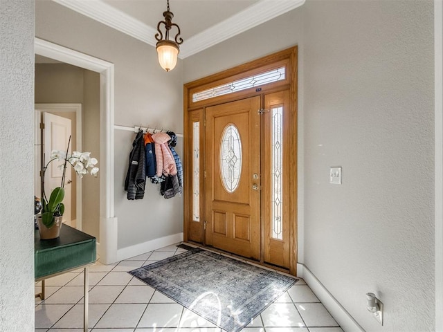 entryway with light tile patterned flooring, crown molding, and baseboards