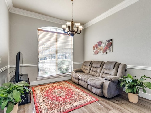 living area featuring ornamental molding, a wealth of natural light, and wood finished floors