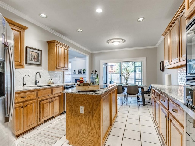 kitchen featuring light tile patterned flooring, a sink, a center island, stainless steel refrigerator with ice dispenser, and light stone countertops