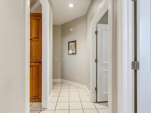 hall with light tile patterned floors and baseboards