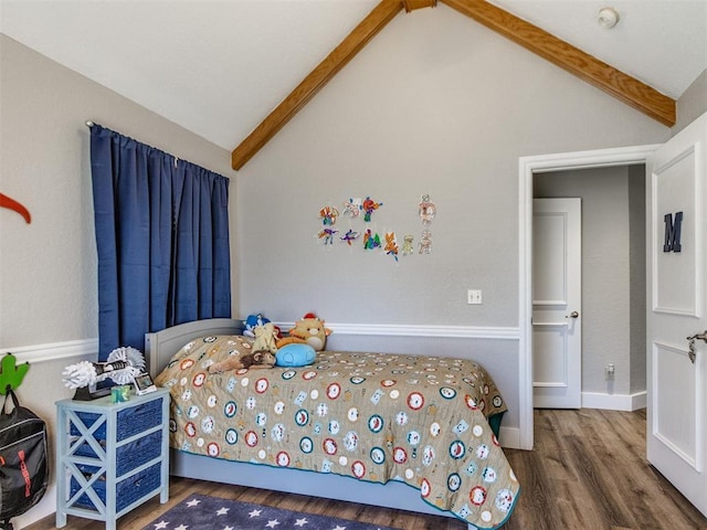 bedroom featuring lofted ceiling with beams and wood finished floors