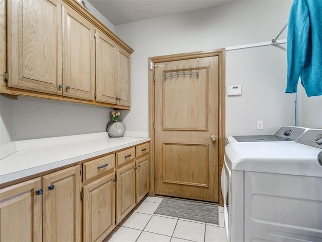 washroom featuring cabinet space, light tile patterned floors, and independent washer and dryer