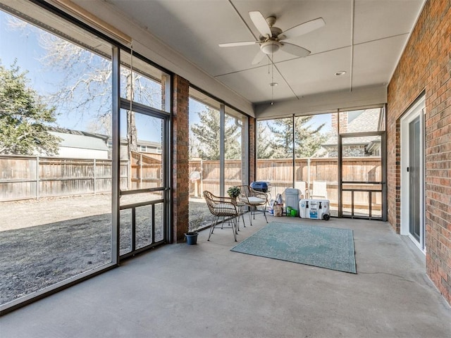 unfurnished sunroom with ceiling fan and a healthy amount of sunlight