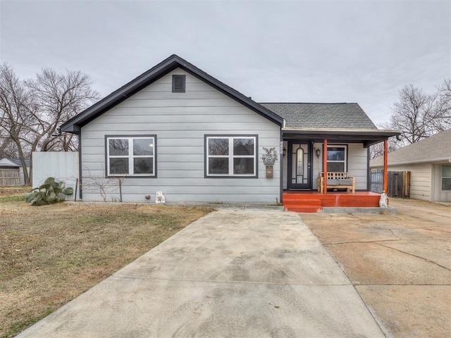 bungalow-style home featuring a porch and a front lawn