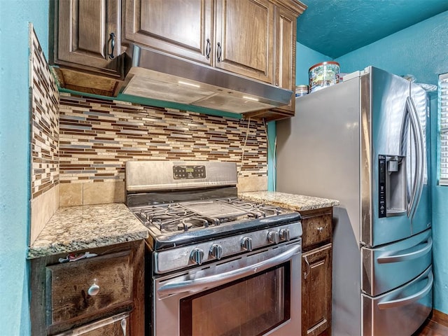 kitchen with stainless steel appliances and decorative backsplash