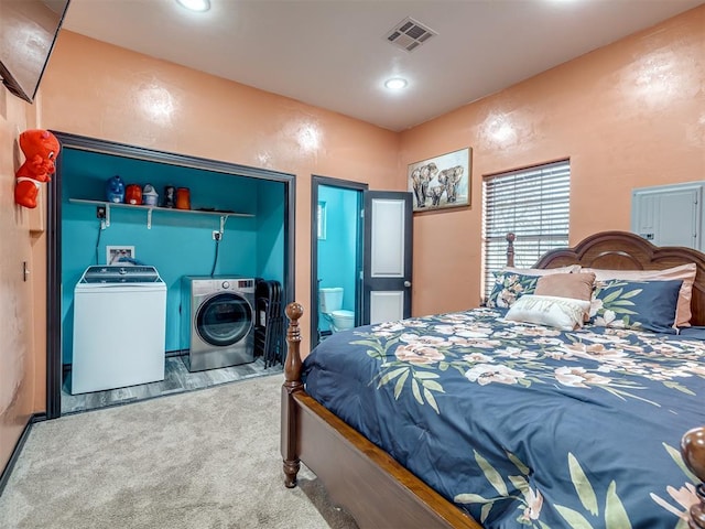 bedroom with independent washer and dryer and carpet flooring