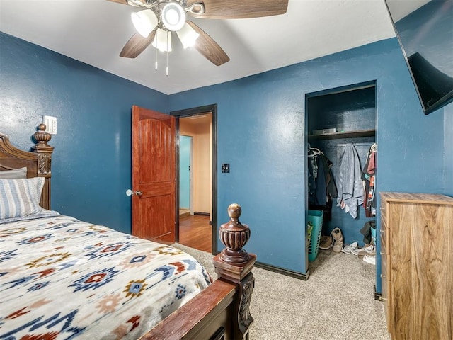 bedroom with light colored carpet, ceiling fan, and a closet