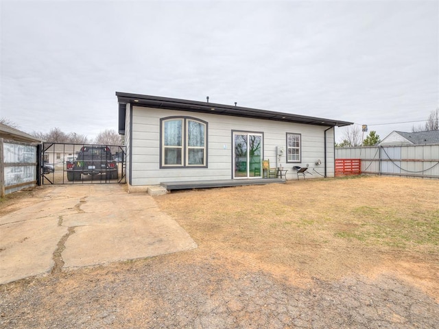 rear view of property with a lawn